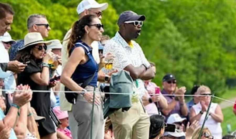 Spectators lining the ropes and applauding at a Ryder Cup