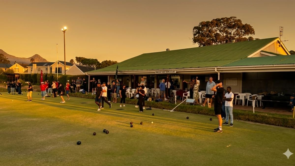 Members playing bowls on the green at Somerset West Bowls Club at golden hour
